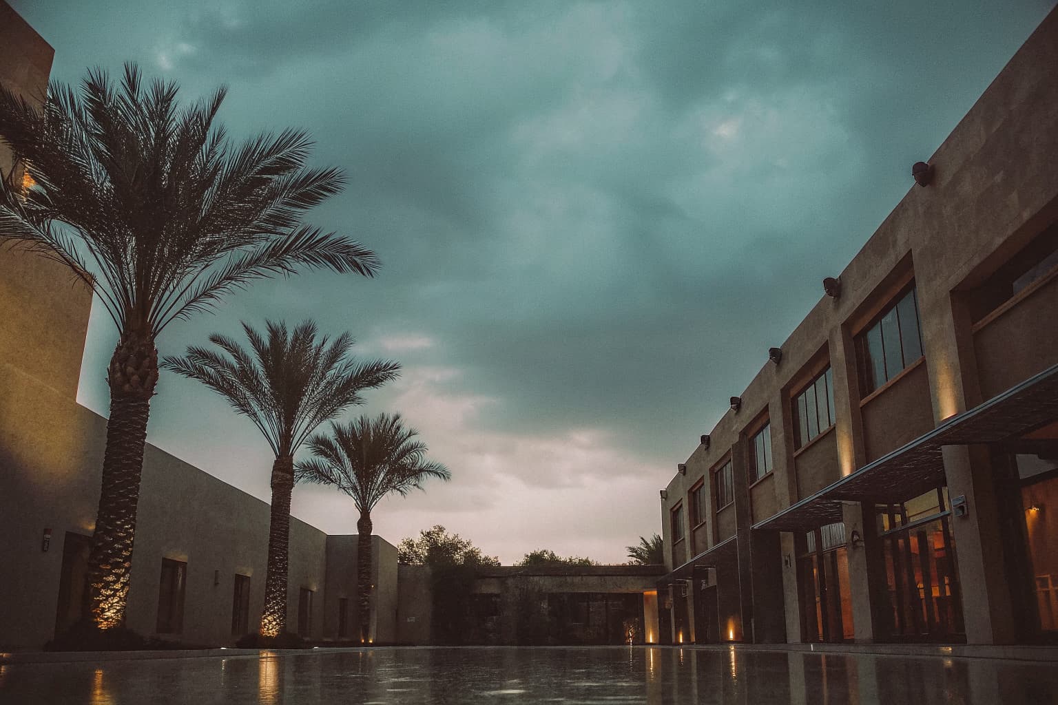 Upscale boutique hotel courtyard and illuminated facade at dusk