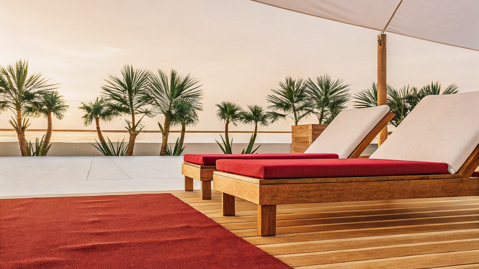 Luxury beachfront resort infinity pool overlooking the ocean at golden hour