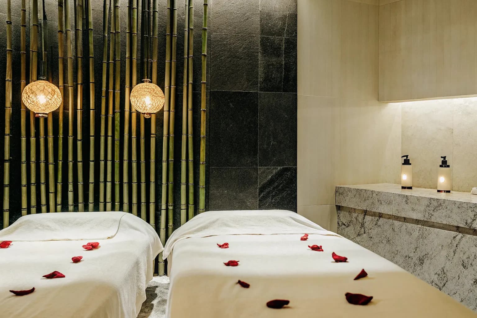 Serene spa treatment room with candlelight and warm amber lighting