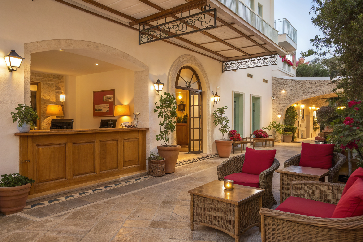 Warm, inviting courtyard entrance of a charming independent boutique hotel at golden hour